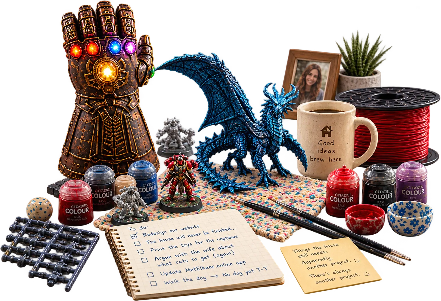 A painted Infinity Gauntlet and blue dragon among miniatures, fresh prints, paint pots, brushes, a filament spool, coffee and a handwritten to-do list.